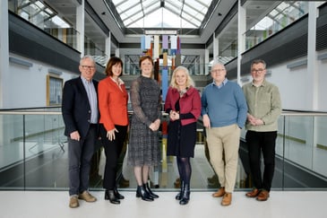 Six white people smiling for a photograph