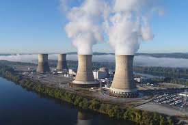 Four tall chimney stacks billowing smoke